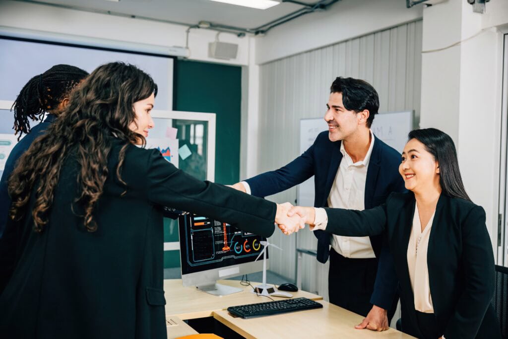 Professionals shaking hands in an office, representing a successful direct hire and temp-to-hire partnership in Oklahoma.