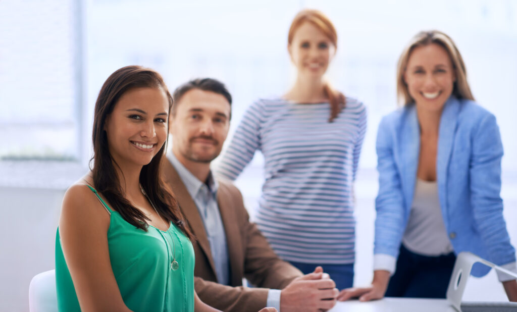 Professional Oklahoma team representing the right staffing partner, smiling and collaborating in a modern office environment.
