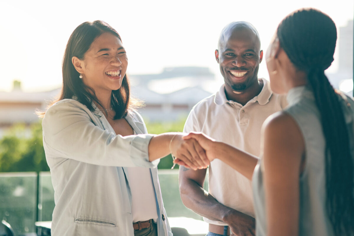 Oklahoma professionals shaking hands outdoors, representing relationship-driven recruiting with an Oklahoma staffing partner focused on hiring success.
