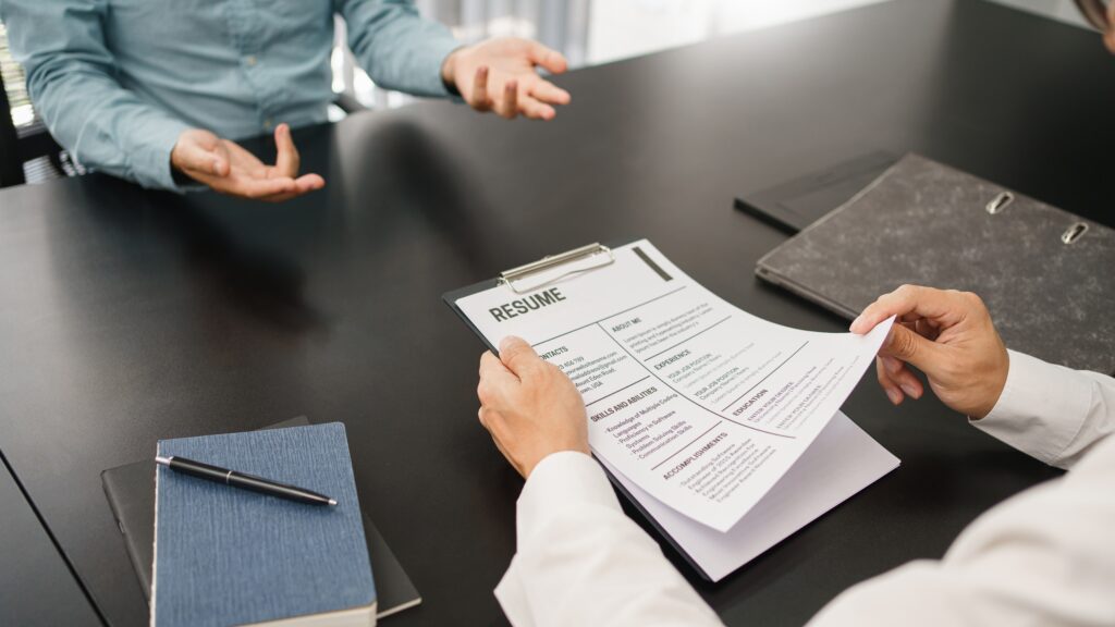 Hiring manager reviewing resume to evaluate candidate quality with support from trusted staffing partner focused on client relationships