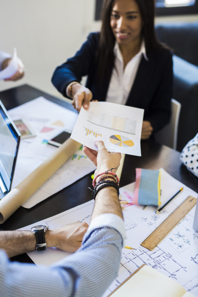 Temp agency in OKC staffing agency candidate sharing documents during hiring discussion with employer.
