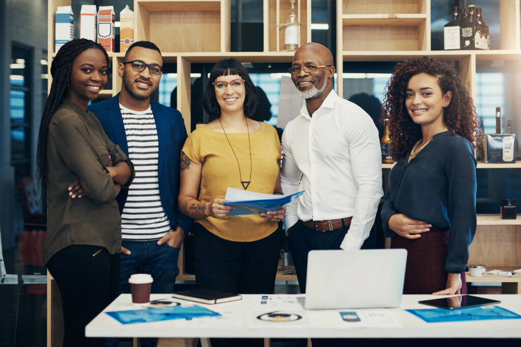 Diverse professionals standing together in an office supported by an Oklahoma staffing agency offering office staffing services and hiring support
