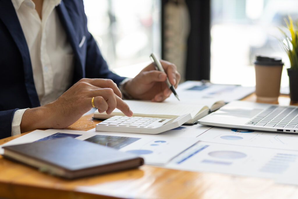 Financial reports, calculator, and business planning materials representing accounting recruiter services, office staffing, and accounting jobs in Oklahoma.