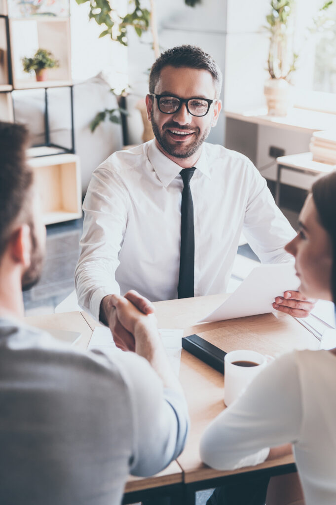 Hiring professional shaking hands with a candidate through Oklahoma job placement services and contract-to-hire staffing.